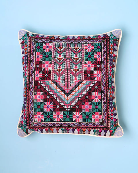 Decorative pillow with geometric pattern on a blue background